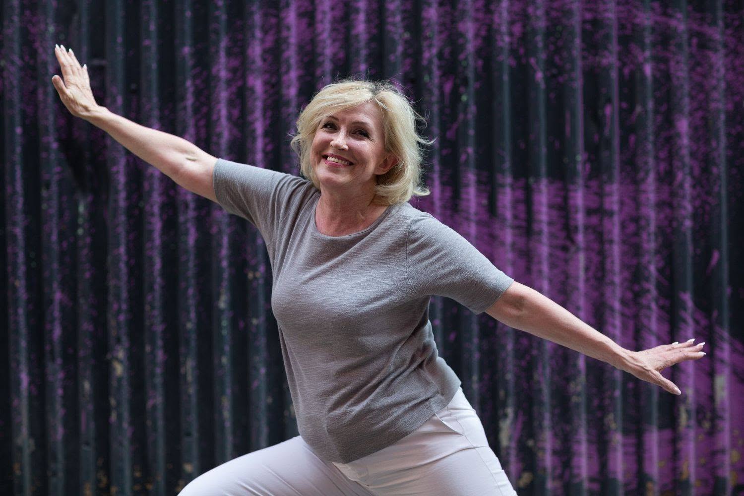 caucasian elderly woman doing qigong exercise summer outdoor