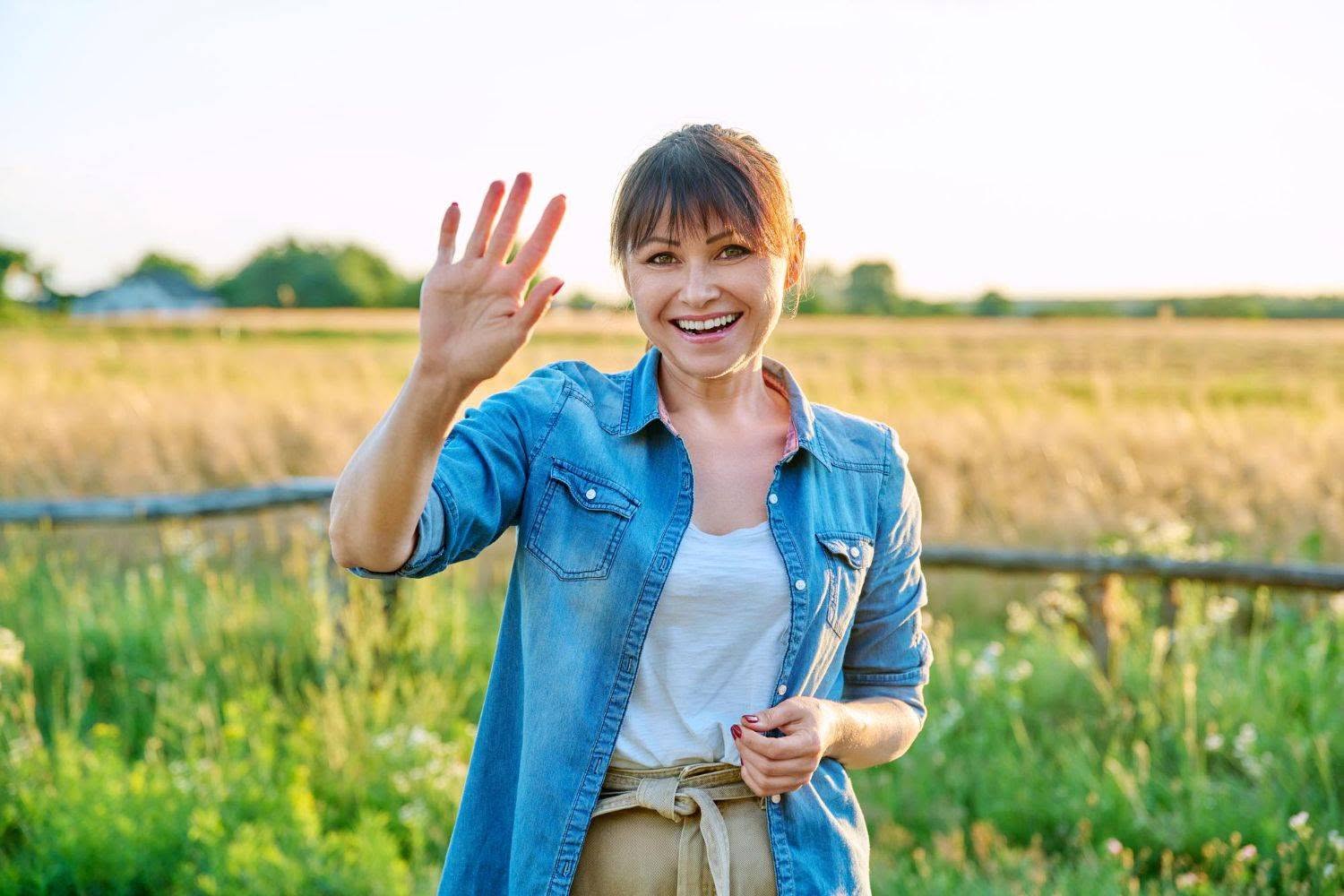 portrait of smiling middle aged woman looking at camera summer countryside (1500x1000)