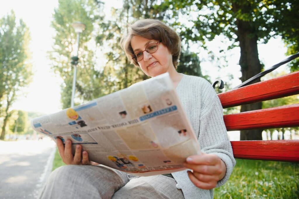 portrait of a happy senior woman in summer park
